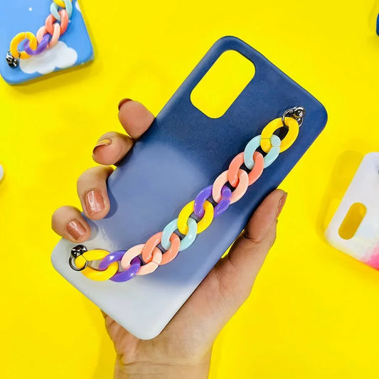 Blue ombre phone case with colorful acrylic chain charm held in hand on yellow background