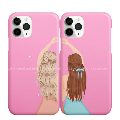Pair of pink phone cases with cartoon best friends making heart shape, sparkles, long hair