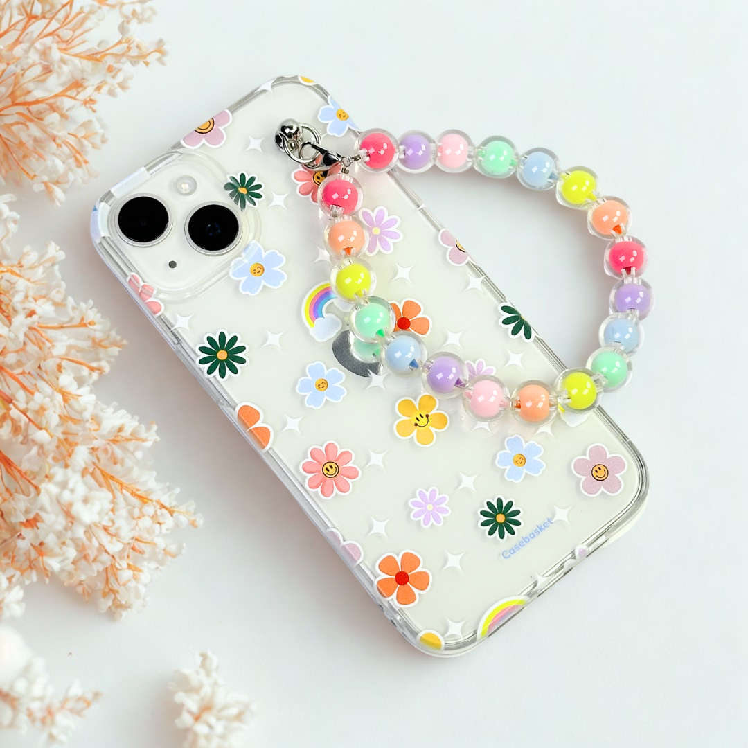 Phone case with floral design and colorful beaded strap on a light background