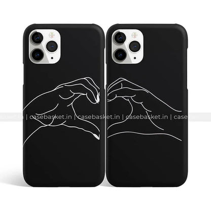 Black couple phone cases with white minimalist hand heart design, perfect for iPhone.